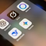 Smartphone screen displays ai app icons: chatgpt, grok, meta ai, gemini.
